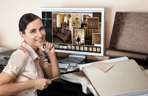 A woman working on designs on her laptop